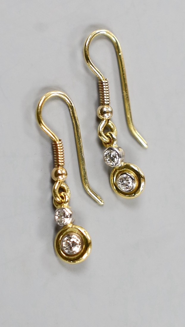 A pair of yellow metal and two stone diamond set drop earrings, overall 25mm, gross weight 2.1 grams.
